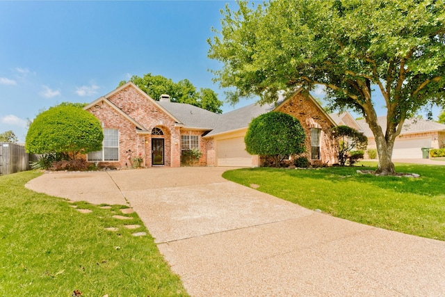 1023 Muirfield Dr, Mansfield, TX 76063 - view of front facade with brick siding, driveway, a garage, and a chimney