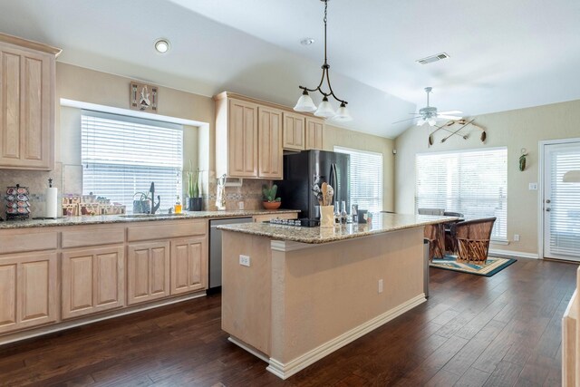 1023 Muirfield Dr, Mansfield, TX 76063 - kitchen featuring stainless steel dishwasher, black fridge with ice dispenser, light brown cabinetry, tasteful backsplash, and lofted ceiling