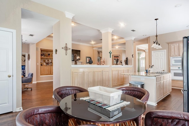 1023 Muirfield Dr, Mansfield, TX 76063 - dining space featuring dark wood finished floors, ornamental molding, decorative columns, and built in features