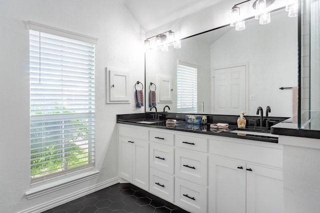 1023 Muirfield Dr, Mansfield, TX 76063 - bathroom featuring double vanity, tile patterned flooring, and plenty of natural light