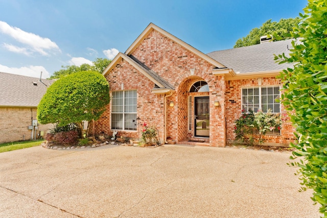1023 Muirfield Dr, Mansfield, TX 76063 - view of front of house featuring brick siding and a shingled roof