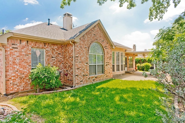 1023 Muirfield Dr, Mansfield, TX 76063 - back of house with brick siding, a patio, a yard, a shingled roof, and a ceiling fan