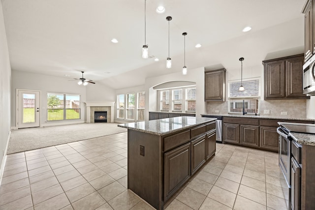 1020 Broken Wheel Trl, Aubrey, TX 76227 - kitchen with ceiling fan, appliances with stainless steel finishes, light tile patterned floors, dark brown cabinetry, and recessed lighting