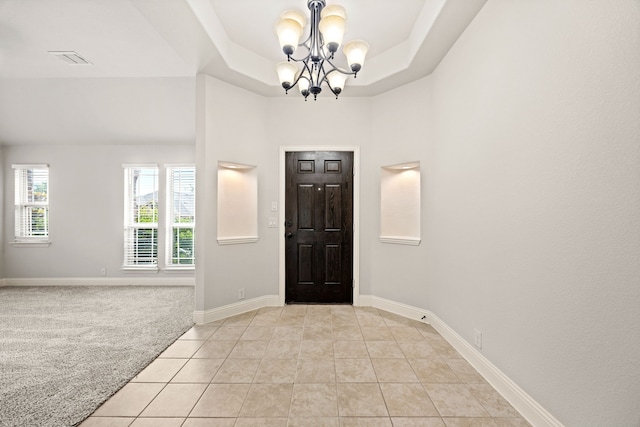 1020 Broken Wheel Trl, Aubrey, TX 76227 - entrance foyer featuring a chandelier, light tile patterned flooring, and a raised ceiling