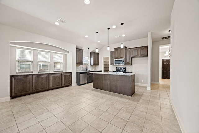 1020 Broken Wheel Trl, Aubrey, TX 76227 - kitchen featuring appliances with stainless steel finishes, dark brown cabinetry, tasteful backsplash, light tile patterned floors, and recessed lighting