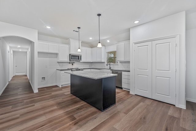 113 Aslan Rd, Poolville, TX 76487 - kitchen featuring stainless steel appliances, a center island, dark wood finished floors, backsplash, and white cabinetry