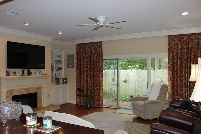 4739 Fairfield Ave Unit 4, Shreveport, LA 71106 - living room featuring wood finished floors, ceiling fan, ornamental molding, a fireplace, and built in features