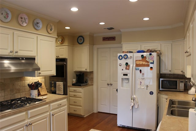 4739 Fairfield Ave Unit 4, Shreveport, LA 71106 - kitchen with stainless steel appliances, under cabinet range hood, light countertops, decorative backsplash, and dark wood-style floors
