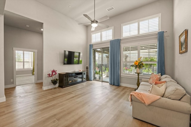 2704 Applewood Way, Wylie, TX 75098 - living area featuring a ceiling fan, wood finished floors, and a towering ceiling