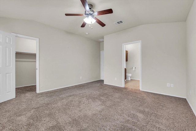 6525 Burling St, Woodway, TX 76712 - unfurnished bedroom with lofted ceiling, carpet flooring, a walk in closet, ensuite bathroom, and ceiling fan