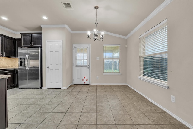 6525 Burling St, Woodway, TX 76712 - kitchen with stainless steel refrigerator with ice dispenser, a chandelier, ornamental molding, backsplash, and light tile patterned floors