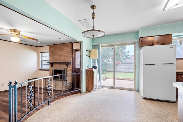 200 Hillcrest Ct, Irving, TX 75062 - kitchen featuring freestanding refrigerator, a brick fireplace, and a ceiling fan