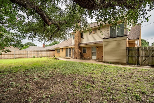 200 Hillcrest Ct, Irving, TX 75062 - rear view of house featuring a balcony, brick siding, a fenced backyard, and a patio area