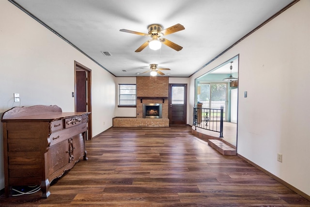 200 Hillcrest Ct, Irving, TX 75062 - unfurnished living room with ceiling fan, dark wood-style flooring, crown molding, and a fireplace