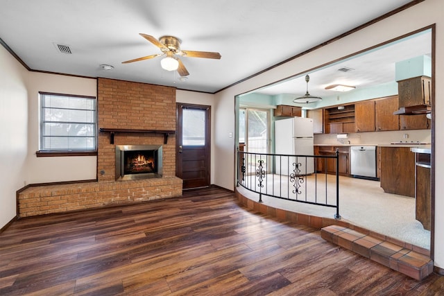 200 Hillcrest Ct, Irving, TX 75062 - unfurnished living room with ceiling fan, wood finished floors, a fireplace, and crown molding