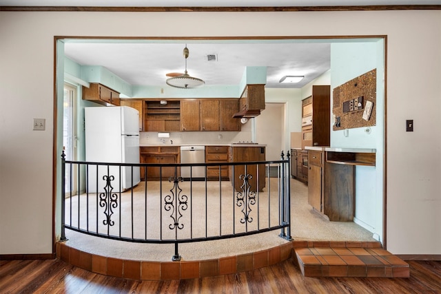 200 Hillcrest Ct, Irving, TX 75062 - kitchen featuring freestanding refrigerator, stainless steel dishwasher, wood finished floors, open shelves, and brown cabinetry