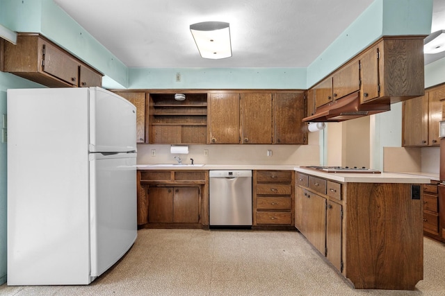 200 Hillcrest Ct, Irving, TX 75062 - kitchen with appliances with stainless steel finishes, under cabinet range hood, open shelves, a peninsula, and light countertops