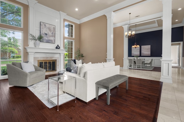 4609 Huffman Ct, Plano, TX 75093 - living room with ornate columns, ornamental molding, a fireplace, recessed lighting, and a chandelier