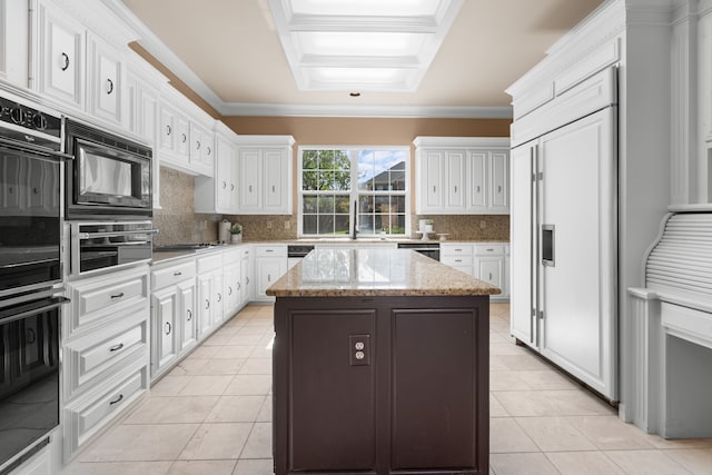 4609 Huffman Ct, Plano, TX 75093 - kitchen with black appliances, light tile patterned flooring, white cabinets, a kitchen island, and ornamental molding