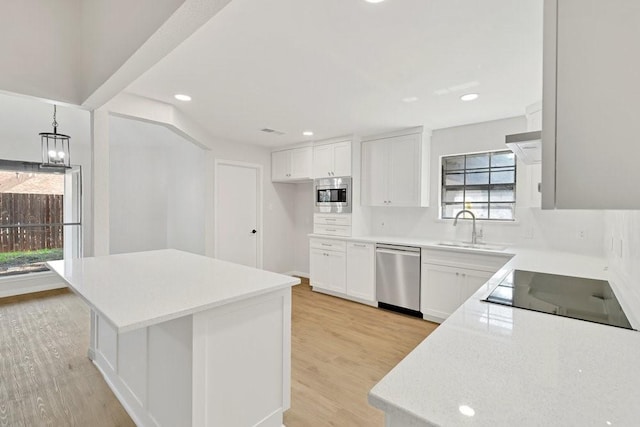 4103 Steeplewood Ct, Arlington, TX 76016 - kitchen featuring appliances with stainless steel finishes, plenty of natural light, a sink, light countertops, and recessed lighting