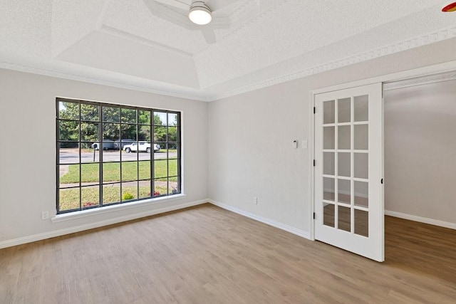 4103 Steeplewood Ct, Arlington, TX 76016 - empty room featuring a tray ceiling, wood finished floors, ceiling fan, baseboards, and a textured ceiling