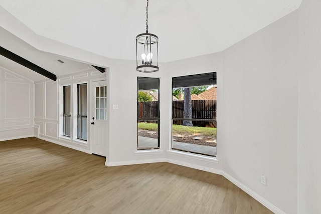 4103 Steeplewood Ct, Arlington, TX 76016 - unfurnished dining area with vaulted ceiling, light wood-style floors, baseboards, and a chandelier