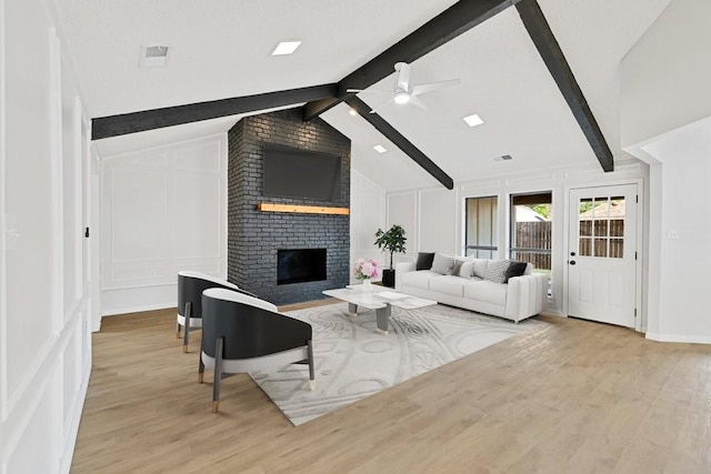 4103 Steeplewood Ct, Arlington, TX 76016 - living area with a decorative wall, wood finished floors, ceiling fan, and a brick fireplace