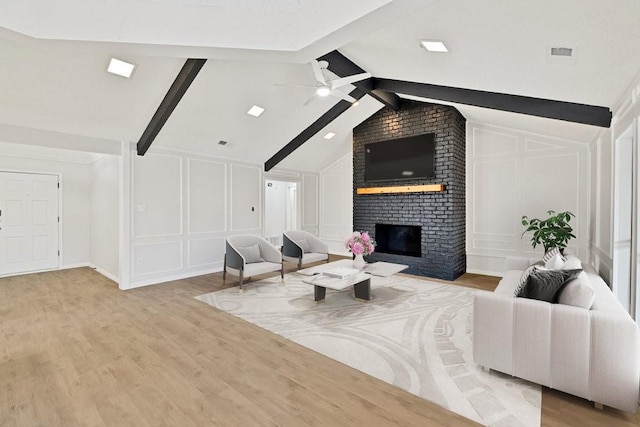 4103 Steeplewood Ct, Arlington, TX 76016 - living area with a decorative wall, light wood-style floors, a brick fireplace, and ceiling fan
