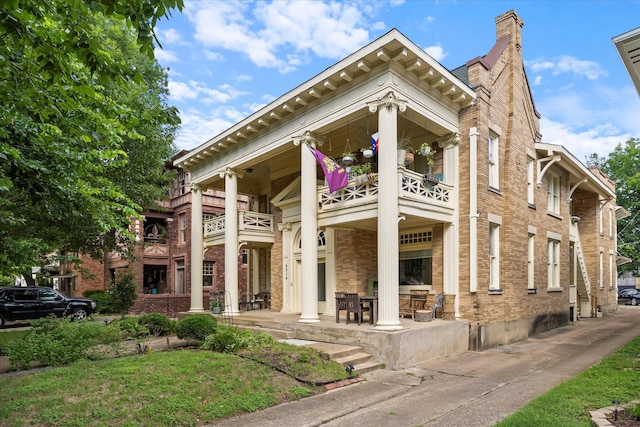 4914 Victor St Unit 1-4, Dallas, TX 75214 - view of front facade featuring a balcony, brick siding, a chimney, and a patio area