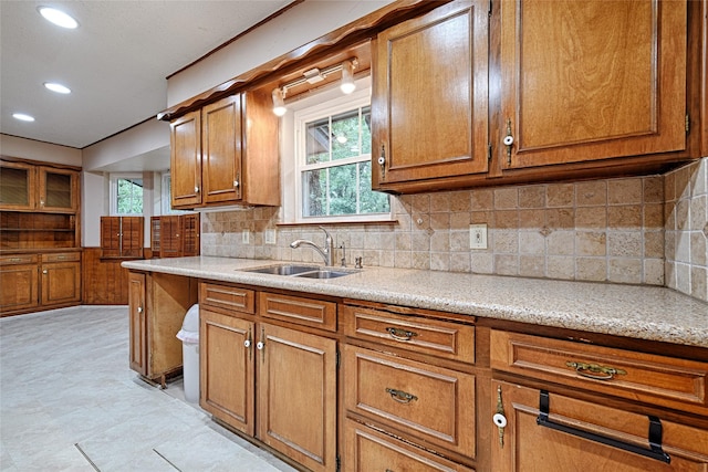 1013 Mountain Ter, Hurst, TX 76053 - kitchen featuring brown cabinets, healthy amount of natural light, backsplash, and recessed lighting