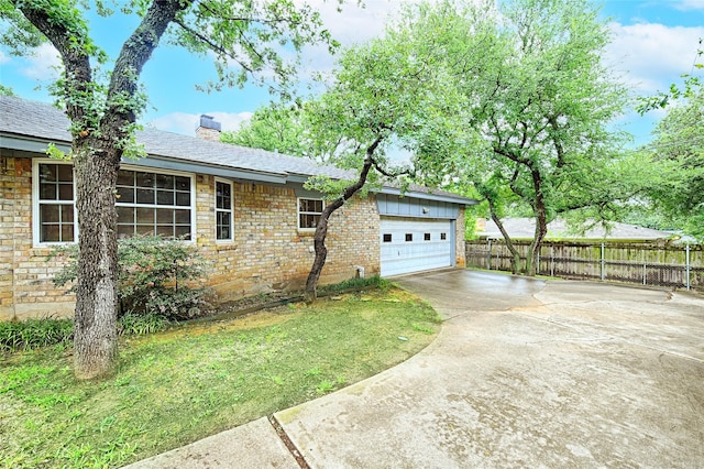 1013 Mountain Ter, Hurst, TX 76053 - view of home's exterior with driveway, an attached garage, a chimney, brick siding, and a shingled roof