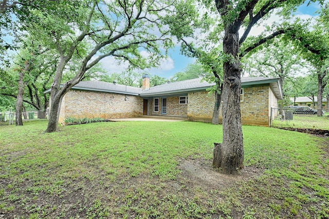 1013 Mountain Ter, Hurst, TX 76053 - rear view of property featuring brick siding, a chimney, and a patio