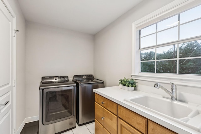 6303 Meadow Rd, Dallas, TX 75230 - laundry room with independent washer and dryer, light tile patterned floors, and cabinet space