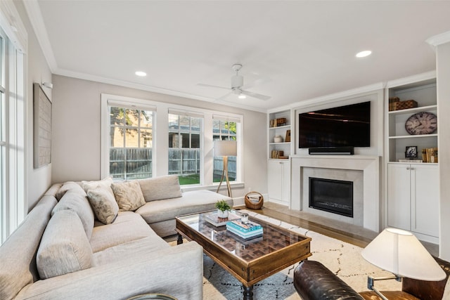 6303 Meadow Rd, Dallas, TX 75230 - living room with crown molding, a ceiling fan, a glass covered fireplace, wood finished floors, and recessed lighting