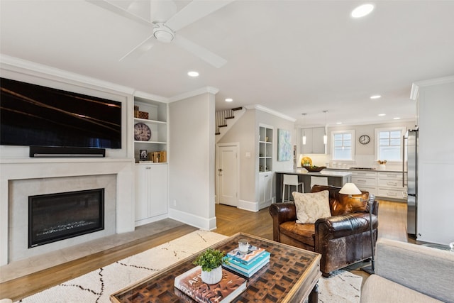 6303 Meadow Rd, Dallas, TX 75230 - living area with ornamental molding, wood finished floors, recessed lighting, ceiling fan, and a high end fireplace
