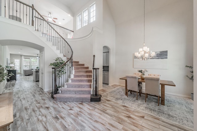 6340 Crossvine Trl, Flower Mound, TX 76226 - entryway featuring arched walkways, stairs, ceiling fan, wood finished floors, and a towering ceiling