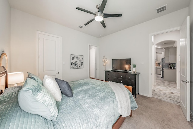 6340 Crossvine Trl, Flower Mound, TX 76226 - bedroom with arched walkways, light colored carpet, a ceiling fan, and freestanding refrigerator