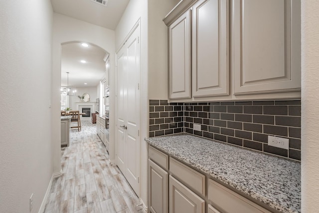 6340 Crossvine Trl, Flower Mound, TX 76226 - hallway featuring arched walkways, light wood-style floors, and recessed lighting
