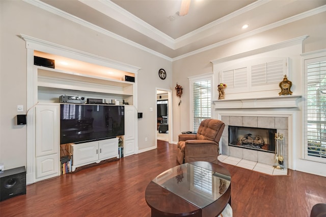 3001 Coventry Ln, Waxahachie, TX 75165 - living room with dark wood-style floors, a tiled fireplace, and crown molding