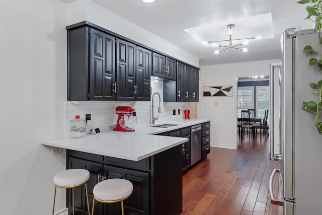 11721 Pine Creek Ct, Fort Worth, TX 76008 - kitchen with stainless steel appliances, a chandelier, a peninsula, light countertops, and decorative backsplash
