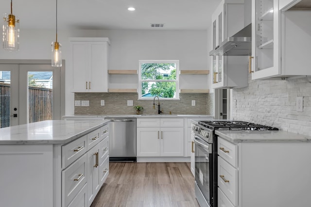 3709 Colonial Ave, Dallas, TX 75215 - kitchen featuring appliances with stainless steel finishes, open shelves, plenty of natural light, white cabinetry, and recessed lighting
