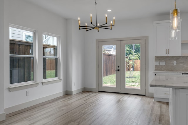 3709 Colonial Ave, Dallas, TX 75215 - unfurnished dining area featuring a chandelier, light wood-style flooring, french doors, and recessed lighting