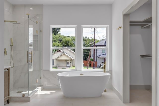 3709 Colonial Ave, Dallas, TX 75215 - bathroom with plenty of natural light, a marble finish shower, a freestanding tub, and tile patterned floors