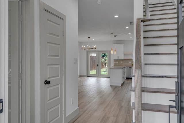 3709 Colonial Ave, Dallas, TX 75215 - staircase featuring recessed lighting, a chandelier, wood finished floors, and french doors