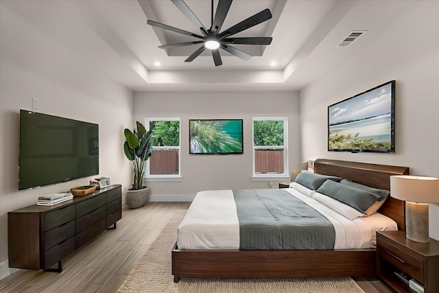 5822 Diaz Ave, Fort Worth, TX 76107 - bedroom with light wood-type flooring, a tray ceiling, recessed lighting, and ceiling fan