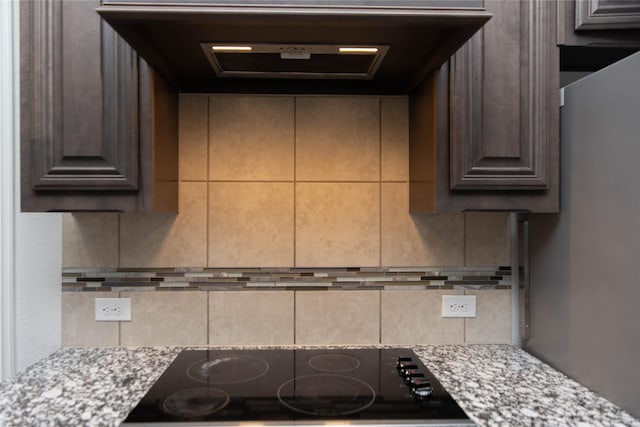 4333 Old Timber Ln, Fort Worth, TX 76036 - kitchen with black electric stovetop, decorative backsplash, dark brown cabinetry, and light stone countertops