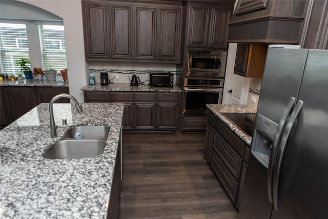 4333 Old Timber Ln, Fort Worth, TX 76036 - kitchen with appliances with stainless steel finishes, dark wood-style floors, dark brown cabinets, backsplash, and light stone countertops