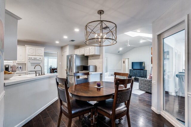 2313 Parkhaven Dr, Plano, TX 75075 - dining area featuring dark wood-style flooring, ceiling fan, a chandelier, recessed lighting, and lofted ceiling