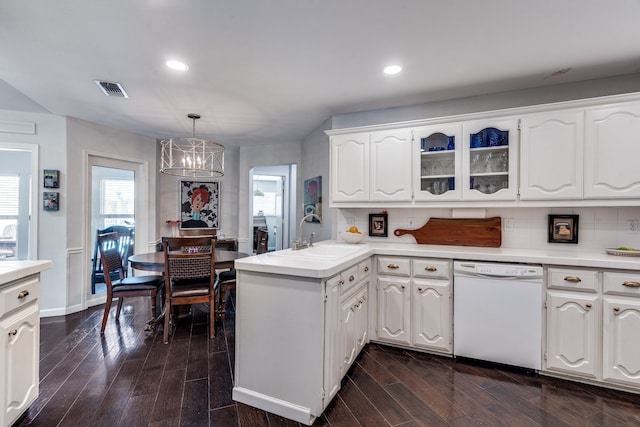 2313 Parkhaven Dr, Plano, TX 75075 - kitchen with white dishwasher, a peninsula, a chandelier, white cabinets, and recessed lighting