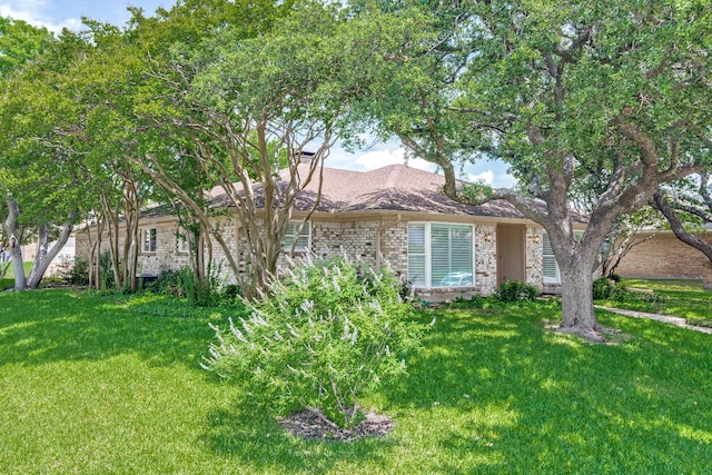 2313 Parkhaven Dr, Plano, TX 75075 - view of front of house featuring a front yard, brick siding, and a chimney